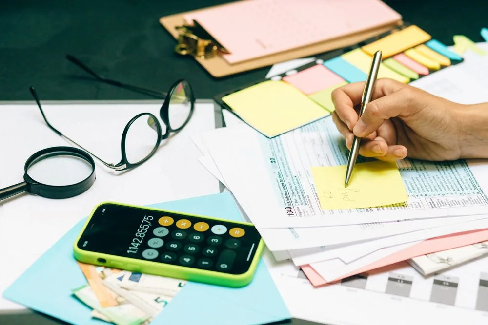 Cash planning notes and calculations on a desk