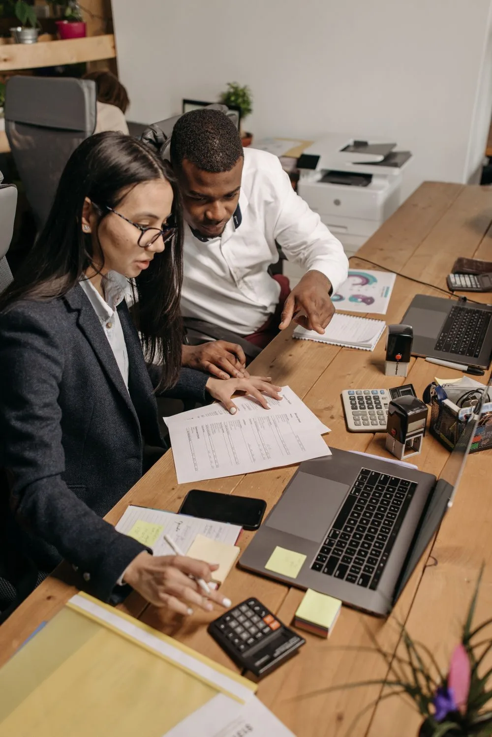 Two colleagues reviewing financial documents together