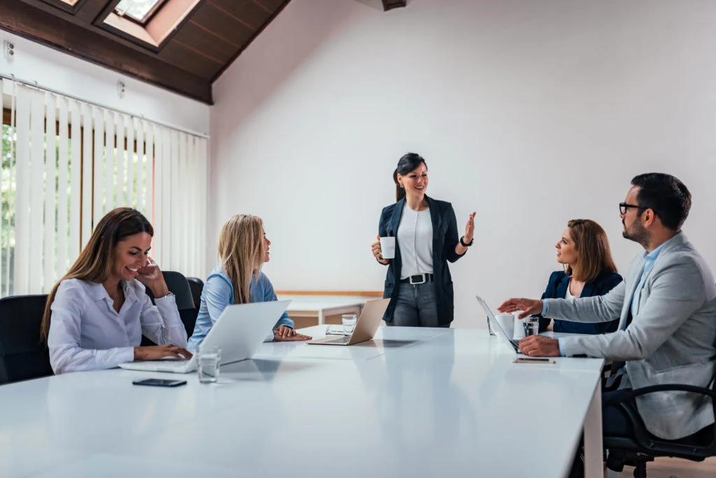 Colleagues discussing business around a conference table